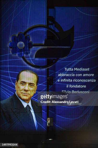 Dedication to Silvio Berlusconi from employees is displayed outside the Mediaset offices, reading "all the Mediaset employees embraces the founder...