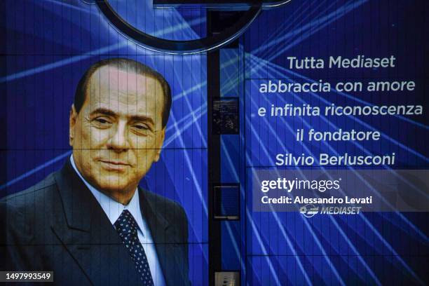 Dedication to Silvio Berlusconi from employees is displayed outside the Mediaset offices, reading "all the Mediaset employees embraces the founder...