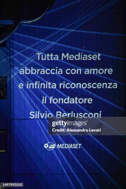 Dedication to Silvio Berlusconi from employees is displayed outside the Mediaset offices, reading "all the Mediaset employees embraces the founder...