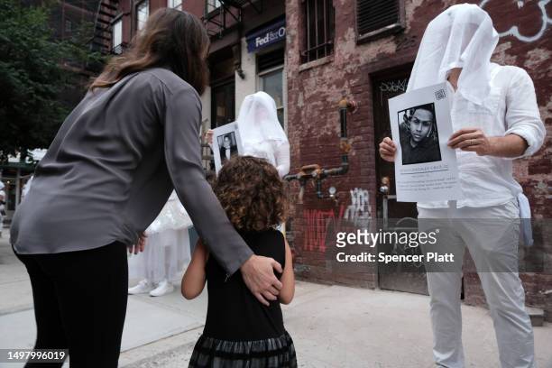 Melanie and her daughter Leni observe members of the activist group Gays Against Guns as they hold a silent vigil to mark seven years since the Pulse...