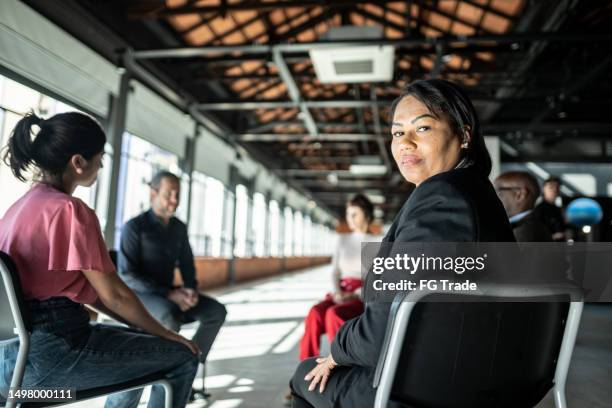 portrait of a mature woman during a group therapy - feedback loop stock pictures, royalty-free photos & images