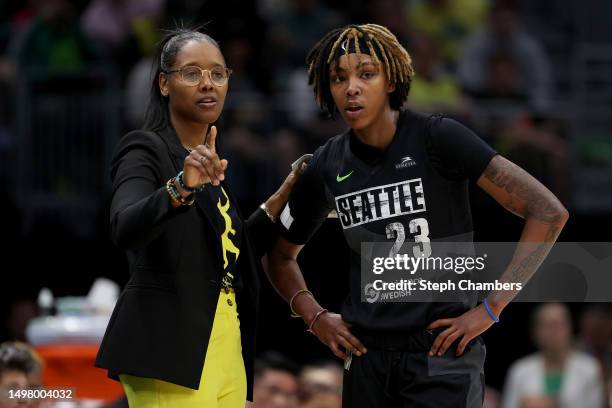 Head coach Noelle Quinn speaks with Jordan Horston of the Seattle Storm during the first quarter against the Washington Mystics at Climate Pledge...