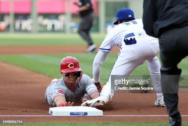 Maikel Garcia of the Kansas City Royals tags out Matt McLain of the Cincinnati Reds as McLain slides headfirst into third base during the 1st inning...
