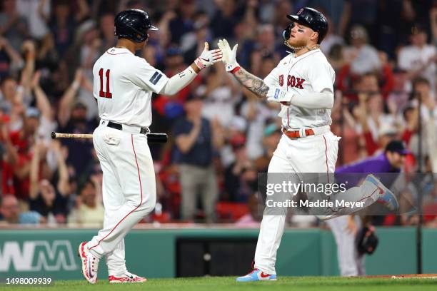 Alex Verdugo of the Boston Red Sox celebrates with Rafael Devers after scoring a run against the Colorado Rockies during the sixth inning at Fenway...