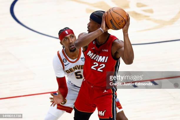 Kentavious Caldwell-Pope of the Denver Nuggets defends against Jimmy Butler of the Miami Heat during the first quarter in Game Five of the 2023 NBA...