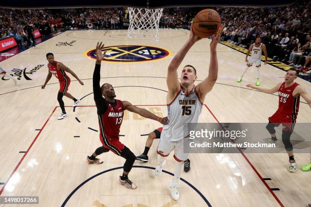 Nikola Jokic of the Denver Nuggets drives to the basket against Bam Adebayo of the Miami Heat during the second quarter in Game Five of the 2023 NBA...