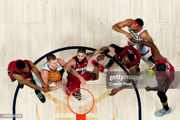 Caleb Martin of the Miami Heat battles Nikola Jokic of the Denver Nuggets for a rebound during the first half in Game Five of the 2023 NBA Finals at...