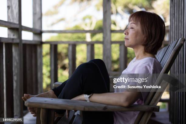 a woman staying at a resort inn on a southern island. - 鹿児島県 stock pictures, royalty-free photos & images