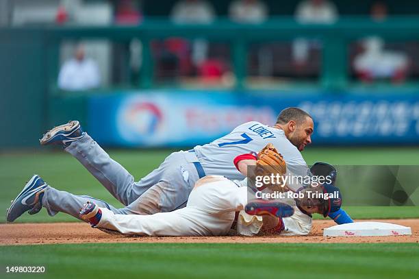 James Loney of the Los Angeles Dodgers slides into second and collides with Mike Fontenot of the Philadelphia Phillies as he defends his position...