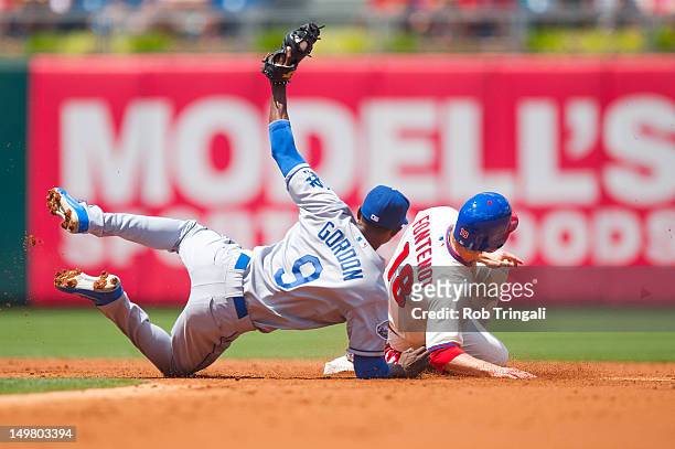 Mike Fontenot of the Philadelphia Phillies slides into second as Dee Gordon of the Los Angeles Dodgers puts the tag on him during the game between...