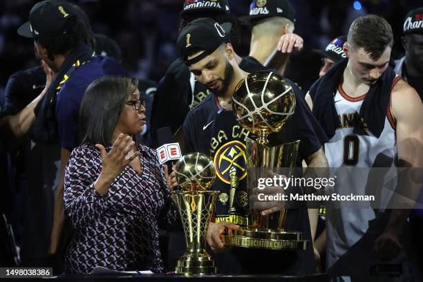 Jamal Murray of the Denver Nuggets is interviewed holding the Larry O'Brien Championship Trophy after a 94-89 victory against the Miami Heat in Game...