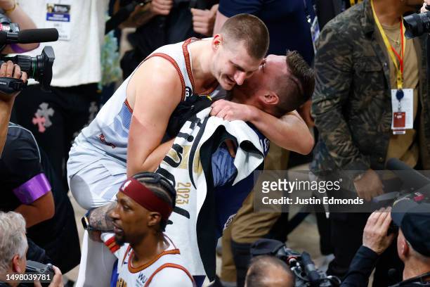 Nikola Jokic of the Denver Nuggets celebrates with his family after a 94-89 victory against the Miami Heat in Game Five of the 2023 NBA Finals to win...