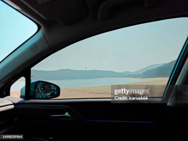 the sea and beach outside the car window - vehículo terrestre fotografías e imágenes de stock