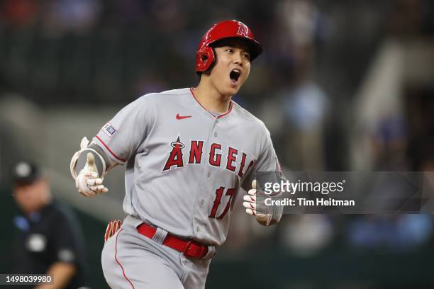 Shohei Ohtani of the Los Angeles Angels reacts after hitting a two-run home run against the Texas Rangers in the 12th inning at Globe Life Field on...