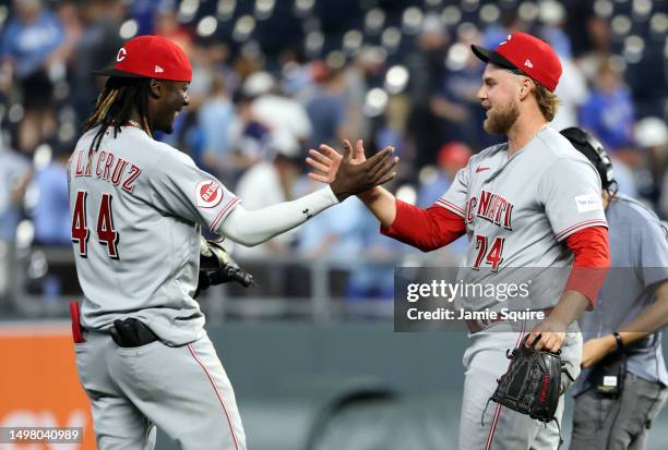 Pitcher Ricky Karcher of the Cincinnati Reds is congratulated by Elly De La Cruz after defeating the Kansas City Royals in the bottom of the 10th...