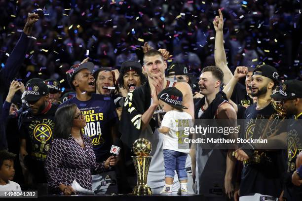 Nikola Jokic of the Denver Nuggets celebrates with the Bill Russell NBA Finals Most Valuable Player Award after a 94-89 victory against the Miami...