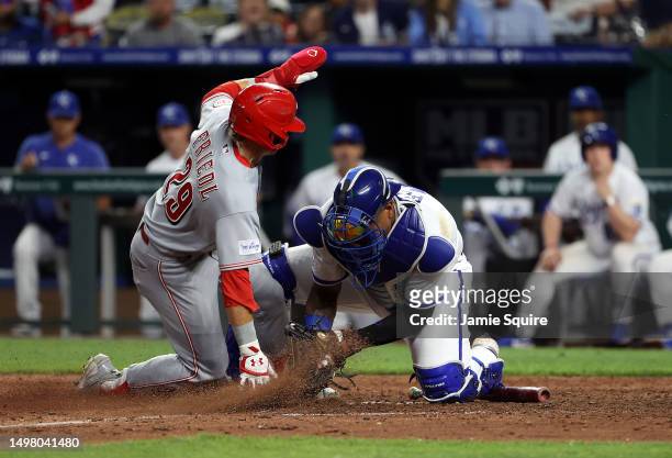 Friedl of the Cincinnati Reds slides into home plate as catcher Salvador Perez of the Kansas City Royals applies the tag during the 10th inning of...