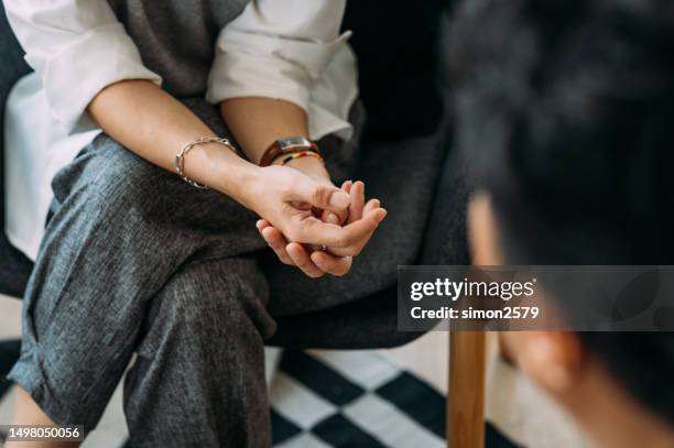 close-up of woman's hands during counseling meeting with a professional therapist. - listening hand stock pictures, royalty-free photos & images