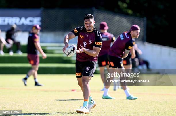 Jeremiah Nanai passes the ball during a Queensland Maroons State of Origin training session at the Clive Berghofer Centre on June 13, 2023 in...