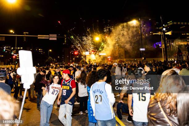 Fireworks light off as Denver Nuggets fans celebrate in the streets of downtown Denver, Colo., after winning Game 5 of the NBA Finals with the Denver...