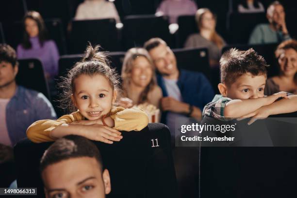 small kids watching a movie in cinema. - filmscreening stockfoto's en -beelden