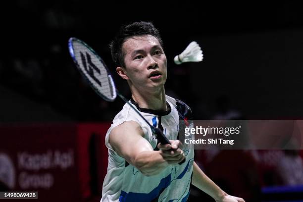 Ng Ka Long Angus of Hong Kong competes in the Men's Singles First Round match against Kento Momota of Japan on day one of the Indonesia Open 2023 at...