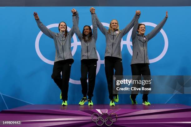 Gold medallists Missy Franklin, Rebecca Soni, Dana Volmer, and Allison Schmitt of the United States celebrates on the podium during the medal...