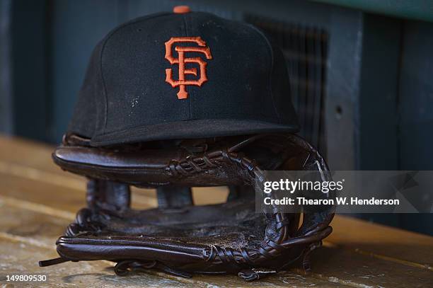 General view of a the San Francisco Giants player hat and glove sitting in the dugout before their game against the New York Mets at AT&T Park on...