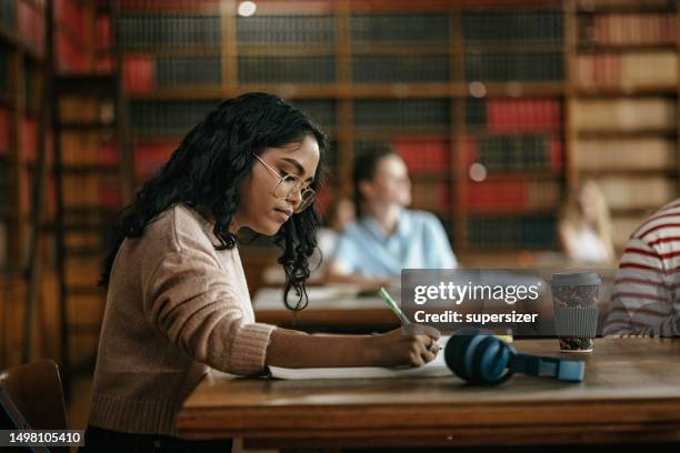 female indian student in the class - university library stock pictures, royalty-free photos & images