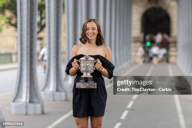 Iga Swiatek of Poland the Women's Singles Final 2023 winner during a photo shoot with the winner's trophy on the Bir-Hakeim bridge during the 2023...