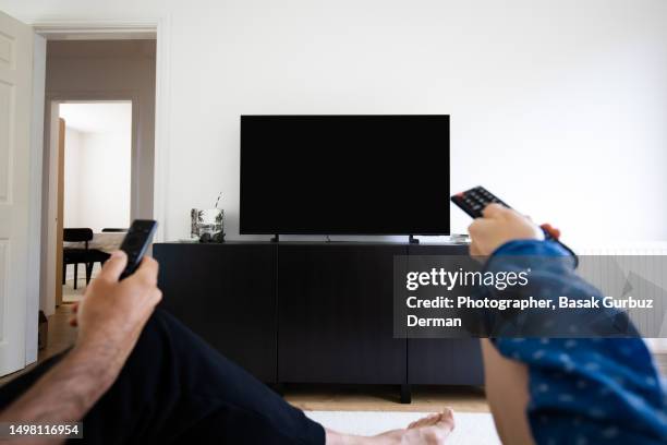 watching tv, using remote control - remote controlled stock pictures, royalty-free photos & images