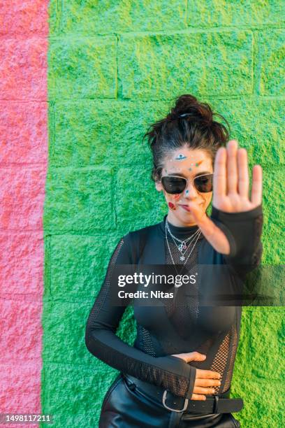 woman with stickers on her face making the stop sign with the hand palm - girl power stickers stock pictures, royalty-free photos & images