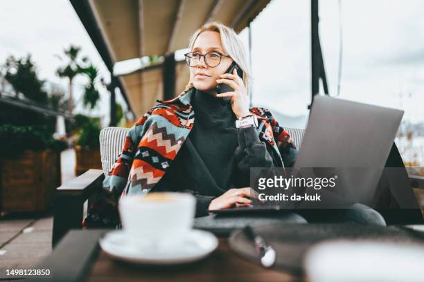 drinking morning coffee and working outdoors remotely making a phone call - café da internet stock pictures, royalty-free photos & images