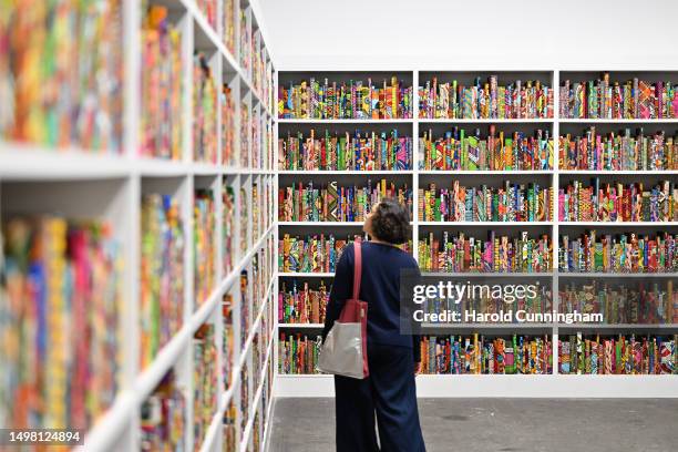 Visitor looks at the artwork of Yinka Shonibare "The African Library", 2018 on June 13, 2023 in Basel, Switzerland. Art Basel is one of the most...