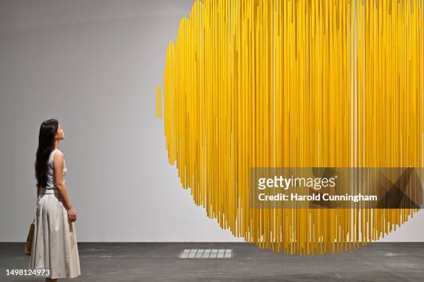 Visitor looks at the artwork of Jesus Rafael Soto "Esfera Amarilla", 1984 on June 13, 2023 in Basel, Switzerland. Art Basel is one of the most...
