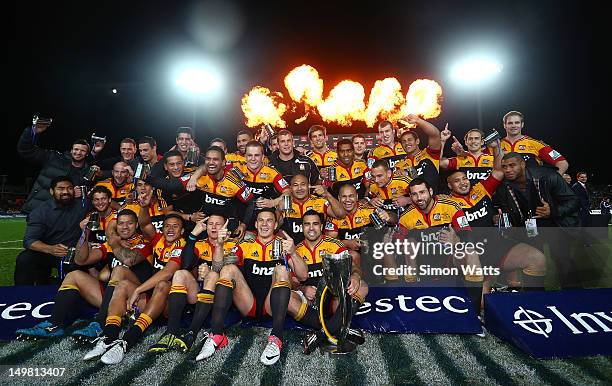 Chiefs players celebrate with the Super Rugby Cup after defeating the Sharks during the Super Rugby Final between the Chiefs and the Sharks at...