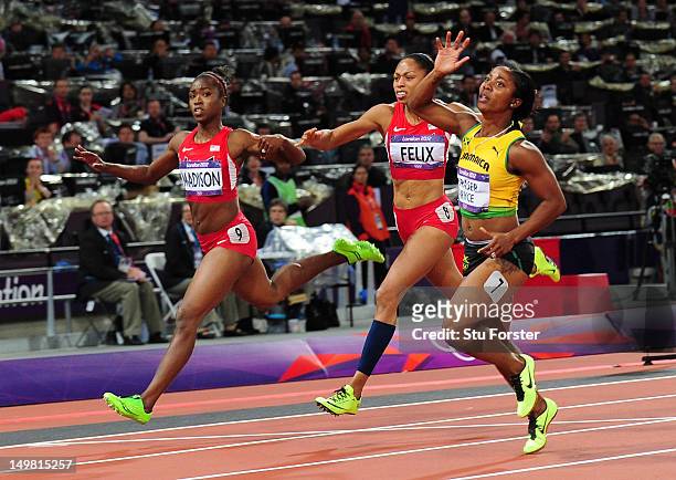 Shelly-Ann Fraser-Pryce of Jamaica crosses the line to win the gold ahead of Allyson Felix of the United States and Tianna Madison of the United...