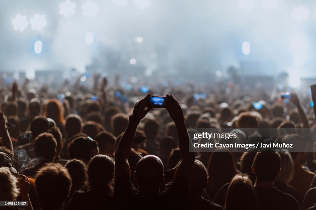 People recording a rock concert with their cell phones