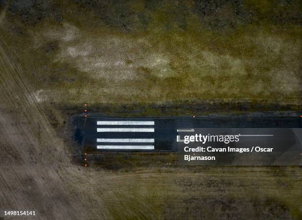 asphalt road with navigational lights on airfield - country road stock pictures, royalty-free photos & images