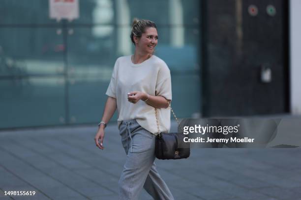 Josephine wearing SoSue beige wide-cut shirt, grey SoSue pants, black Loewe bag with a golden chain, silver jewelry on June 08, 2023 in Hamburg,...