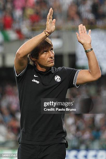 Antonio Conte the coach of FC Juventus greets the fans during the pre-season friendly match between FC Juventus and Malaga CF at Stadio Arechi on...