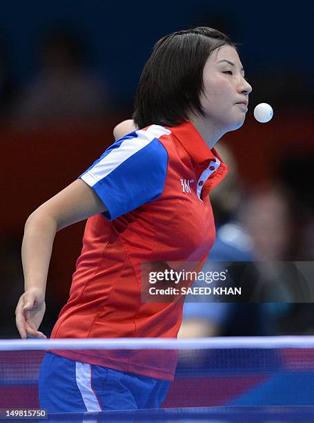 Kim Jong of North Korea serves to Feng Tianwei of Singapore during a table tennis women's team match of the London 2012 Olympic Games at the Excel...