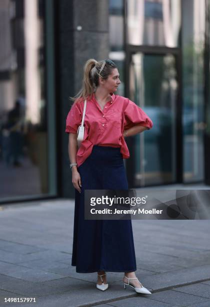 Josephine Kröger wearing blue SoSue long skirt, red SoSue oversized blouse, beige small Celine bag and beige Celine heels on June 08, 2023 in...
