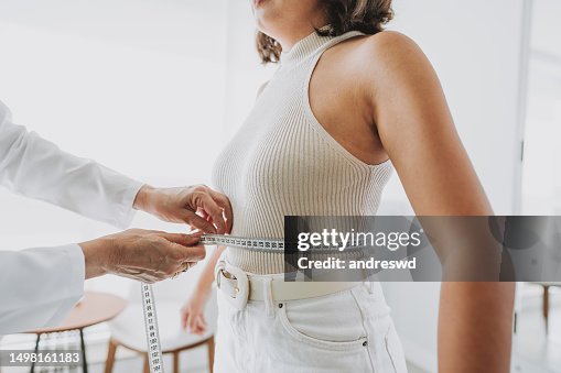 Woman measuring belly fat Woman measuring belly fat