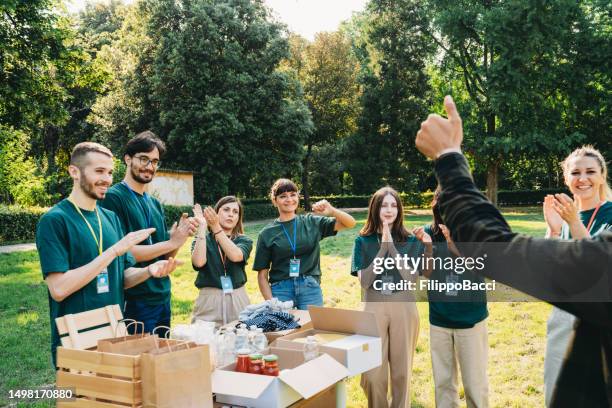 volunteers are celebrating together the success of their project - circle badge stock pictures, royalty-free photos & images