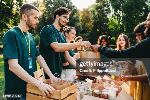 A couple is taking a bag of food at the food and clothes bank