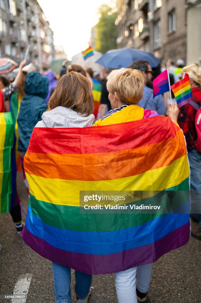 Lesbian women wearing flags during pride event