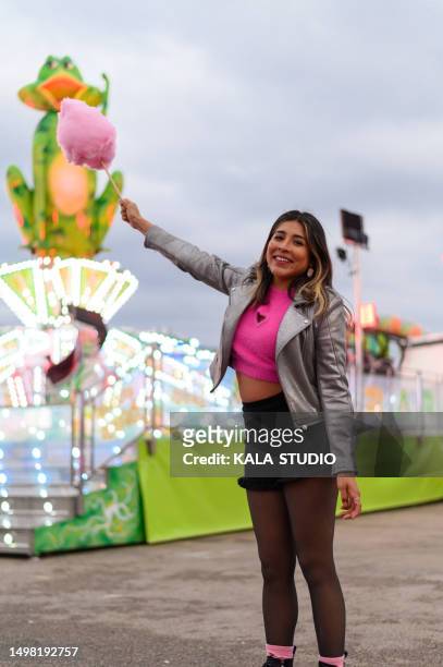 woman joking with a cotton candy in a fair - woman frog hand stock-fotos und bilder