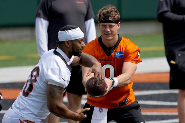 Joe Mixon and Joe Burrow of the Cincinnati Bengals participate in a drill during an offseason workout on June 13, 2023 in Cincinnati, Ohio.