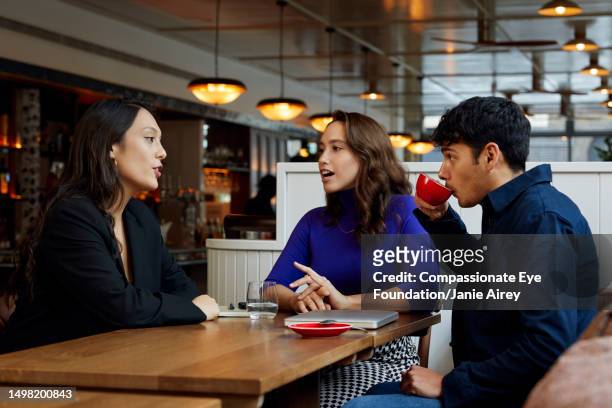 business colleagues having meeting in cafe - cup day three stock pictures, royalty-free photos & images